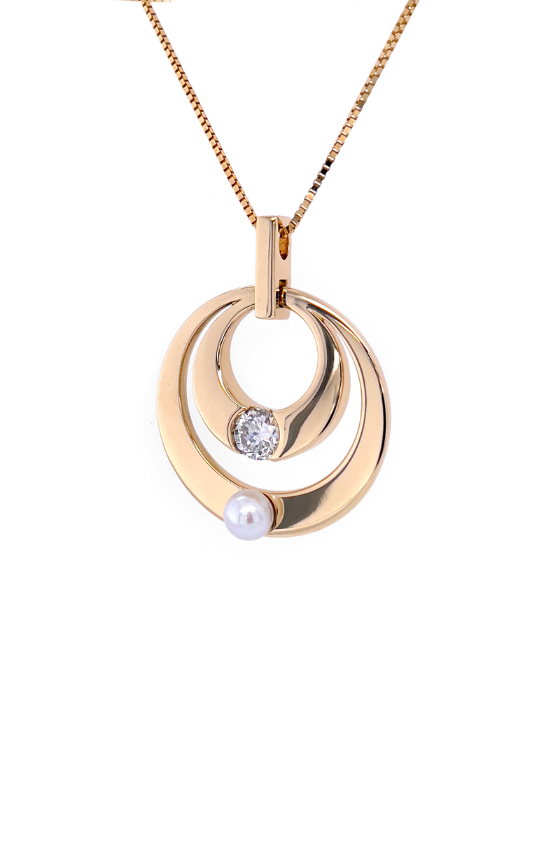Custom 14k yellow gold pendant and chain with a diamond set in a half bezel and a pearl set below