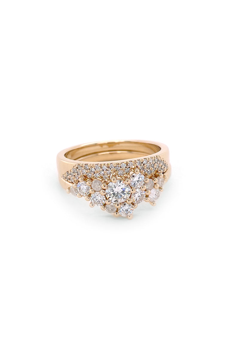 Custom 14k yellow gold wedding set with a diamond cluster engagement ring and a diamond pave scatter band