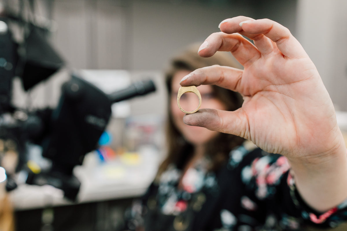 Neeter house jeweler holds up a ring they're repairing at bellingham, wa jewelry store